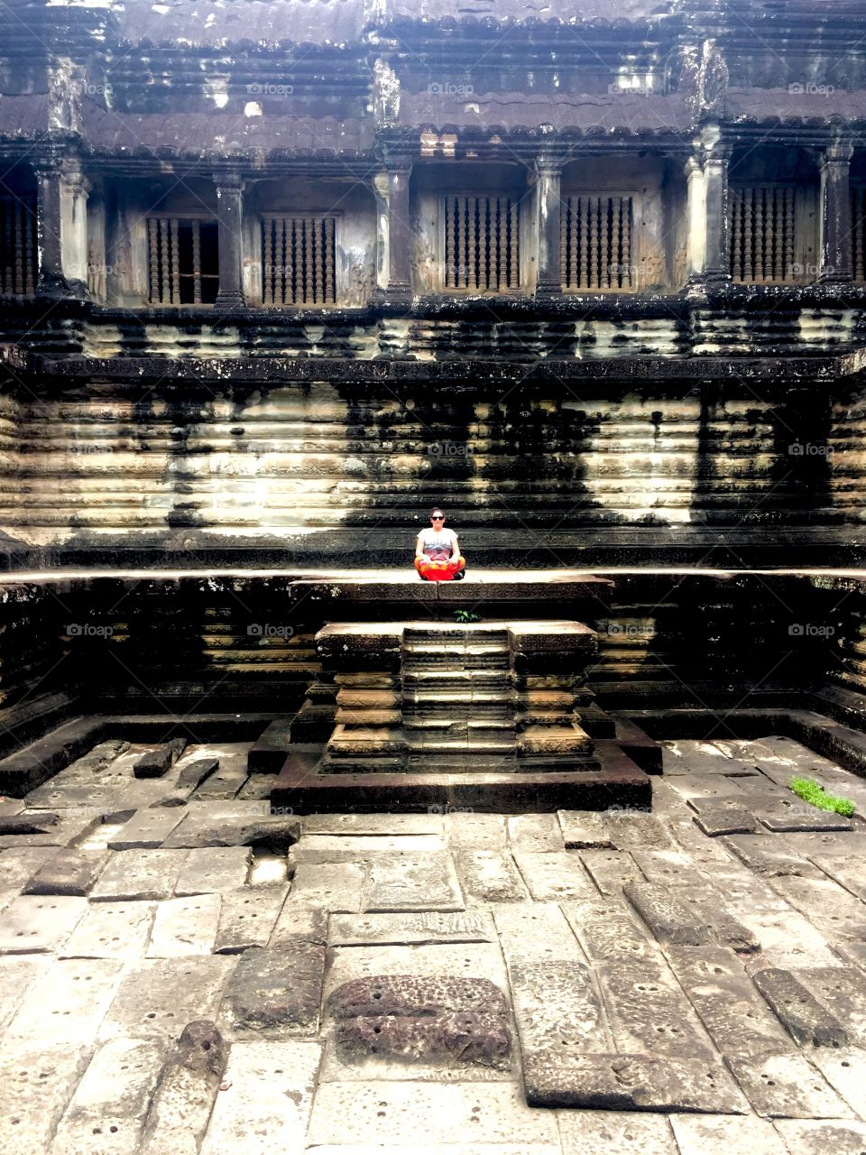 Woman in meditation position in Angkor Wat