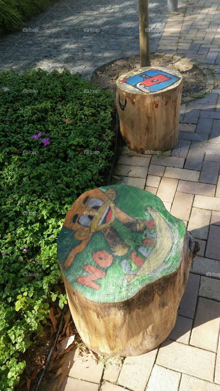 promoting art done by children. meaningful usage of discarded tree trunks