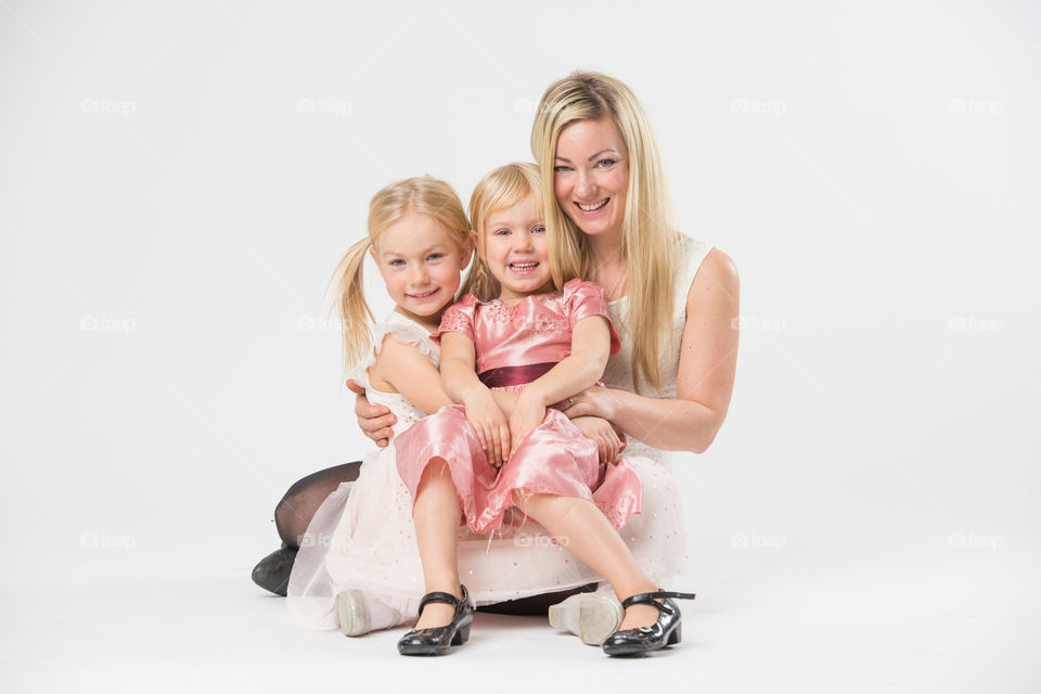 Happy family, mother with her two daughters of 6 and four years old.