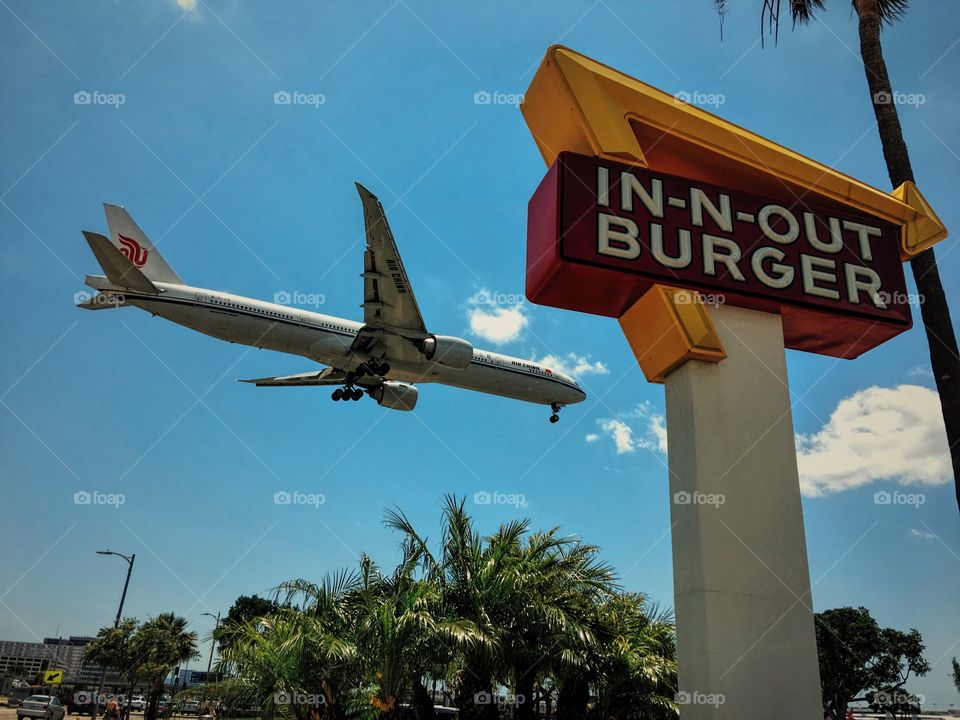 An Air China Boeing 777 flying over In-N-Out for landing