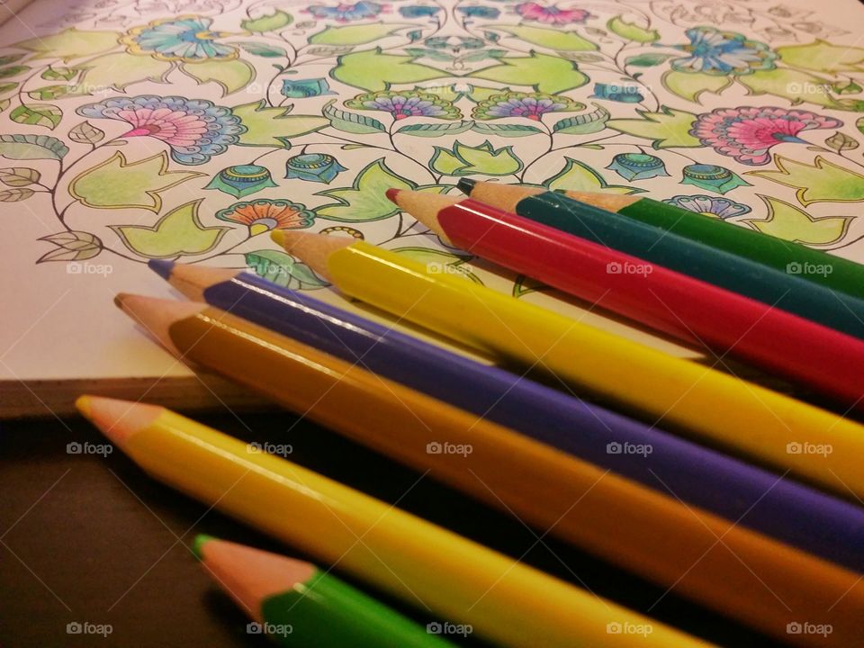 Coloured pencils and stress relieving adult colouring book