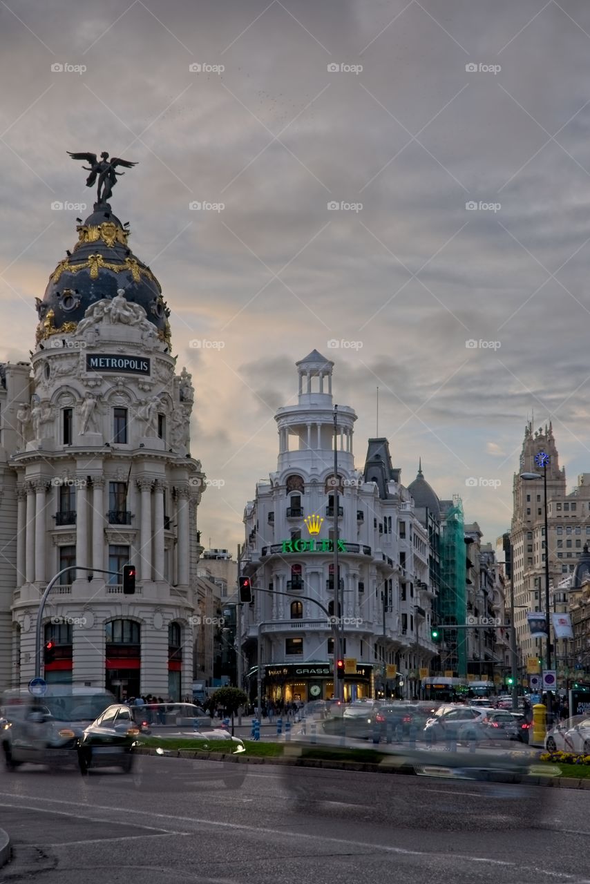 Traffic on the move in Madrid downtown at sunset 