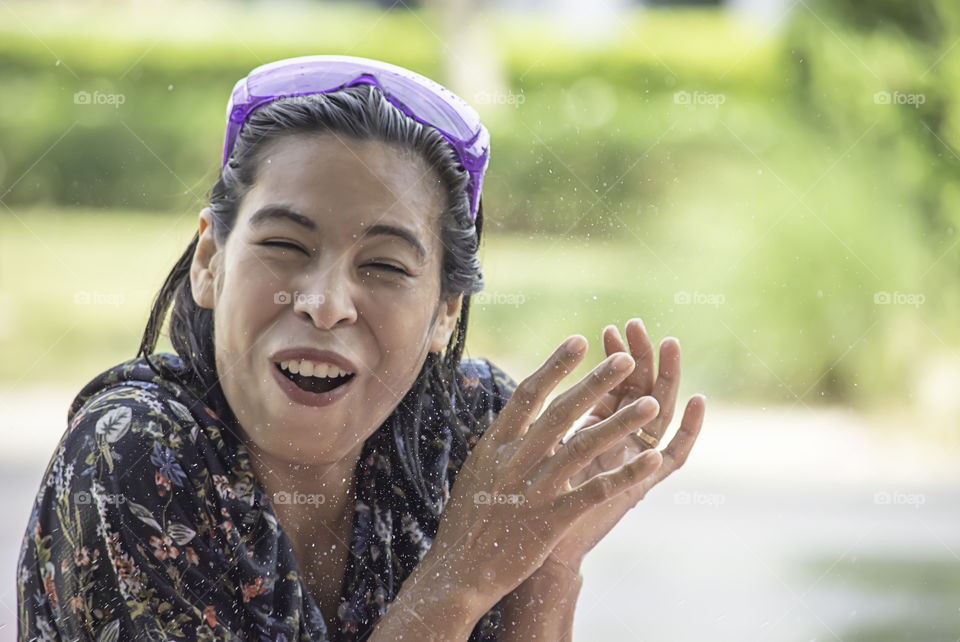 Asian woman play water in Songkran festival or Thai new year in Thailand.