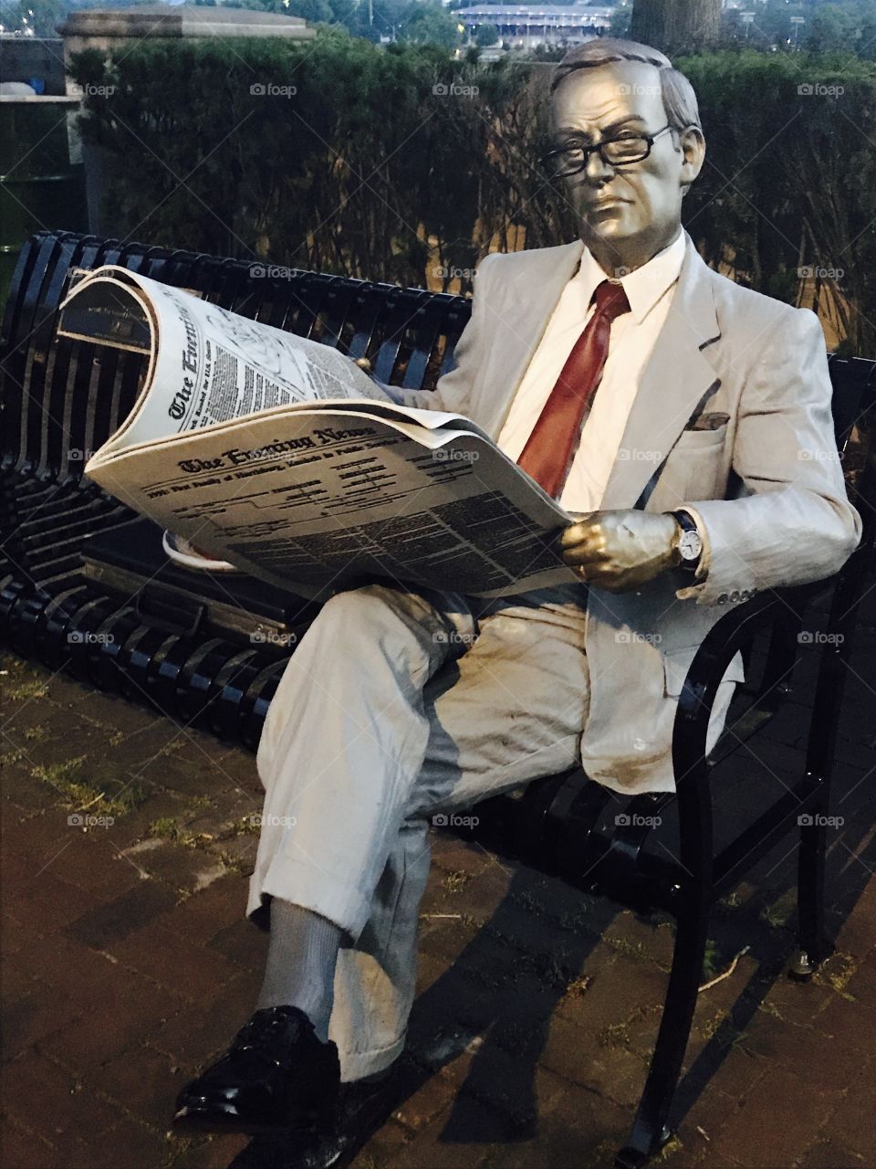 Bronze Businessman Statue Reading the Newspaper on Front Street in Downtown Harrisburg, PA