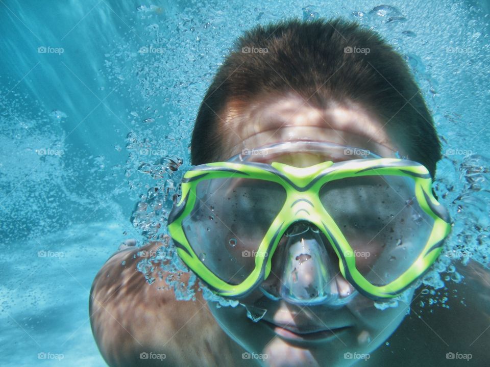 Close-up of a man swimming underwater