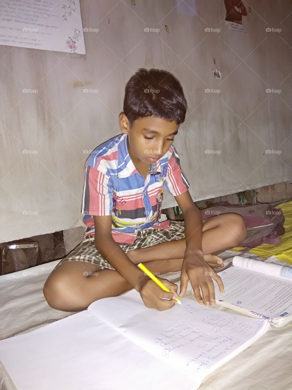 The boy is wtiting and learning