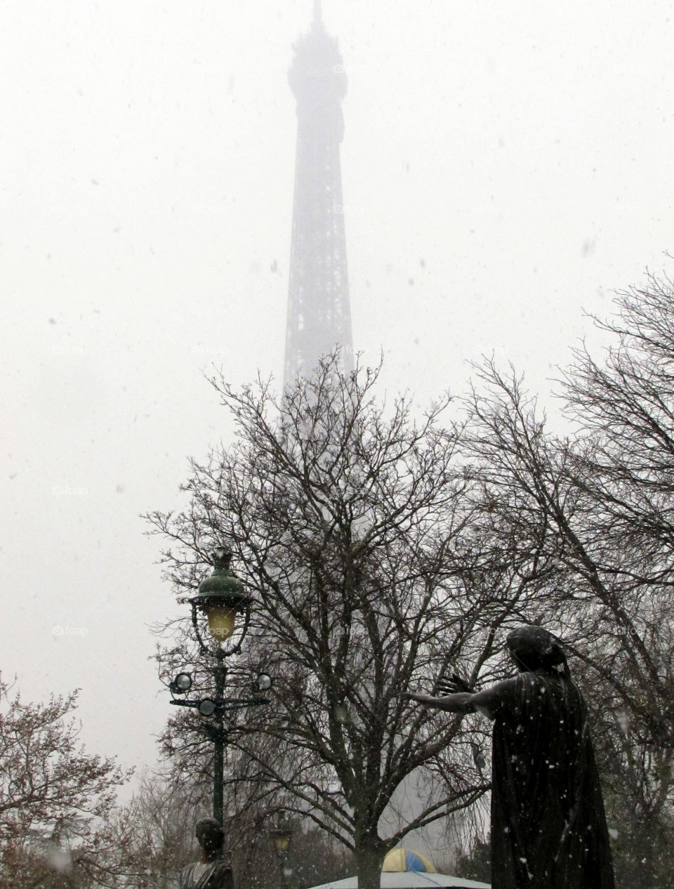 grey Eiffel tower in paris under the snow