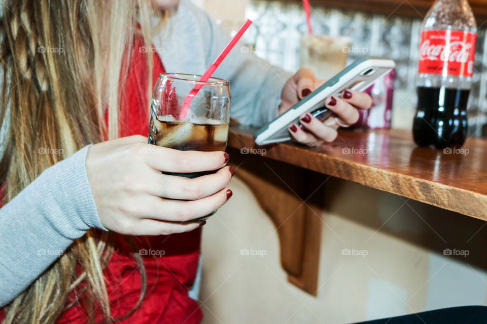 Refreshing Cola- sitting and texting with a CocaCola 
