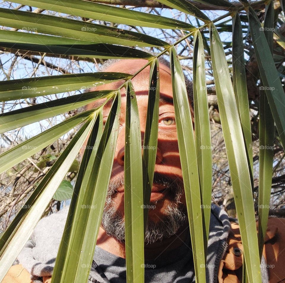 Obstructed portrait of a man taking a hike in nature