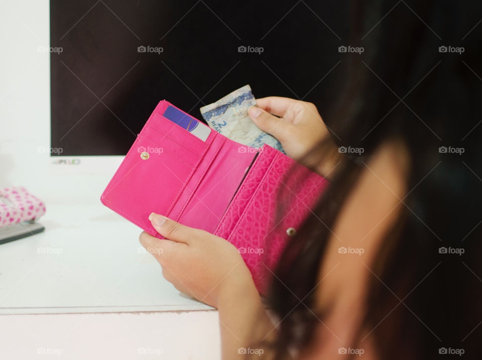 Woman taking money off the wallet 