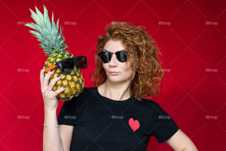 beautiful red-haired girl with pineapple with cool emotions