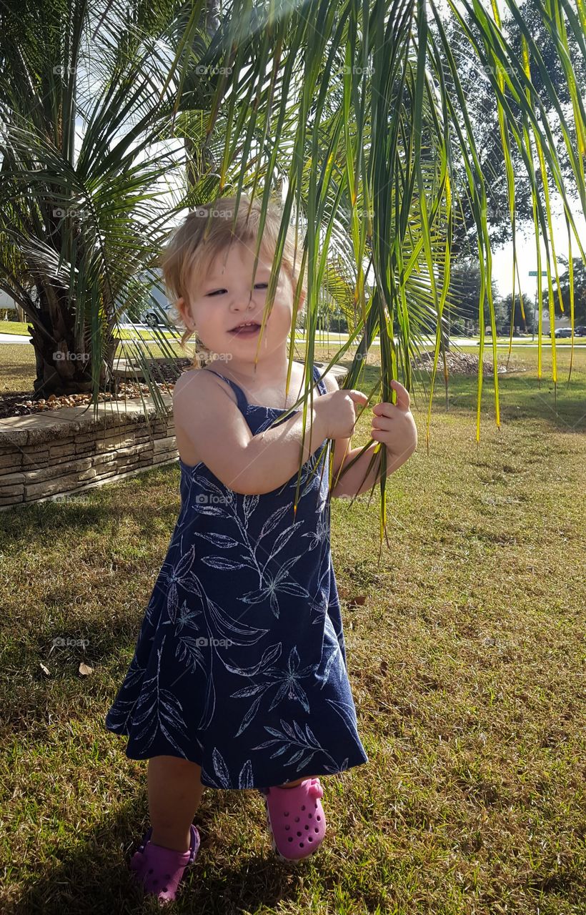 Cute little girl standing in park