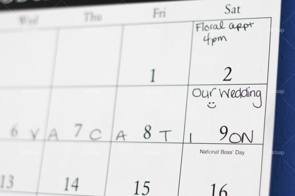 A calendar with handwriting indicating wedding events, including the big day itself!