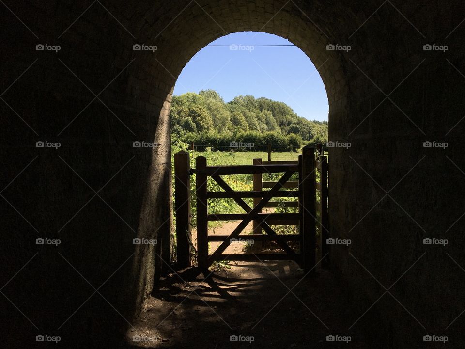 Local riverside walk going under an old bridge 