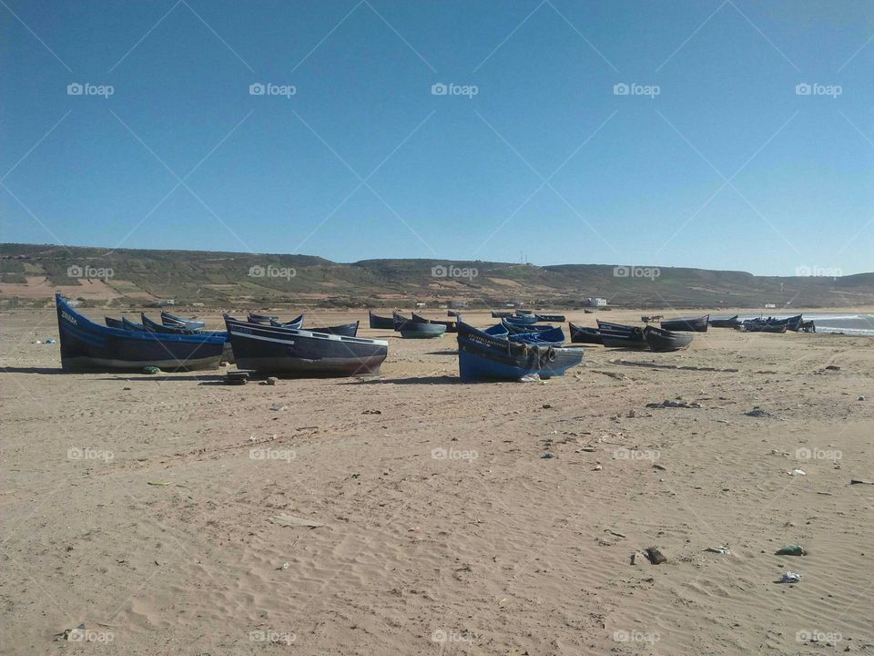 a group of boats on sand at essaouira in Morocco.