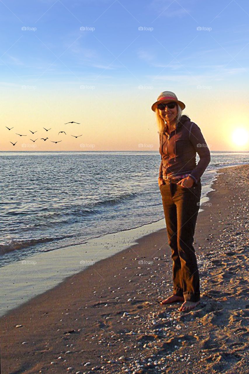 Woman on the beach at sunset