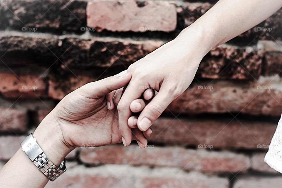 Close-up of couple holding hands