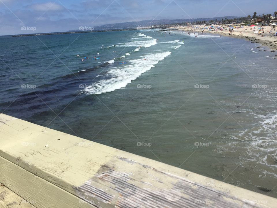 beach waves with a view of ocean from pier