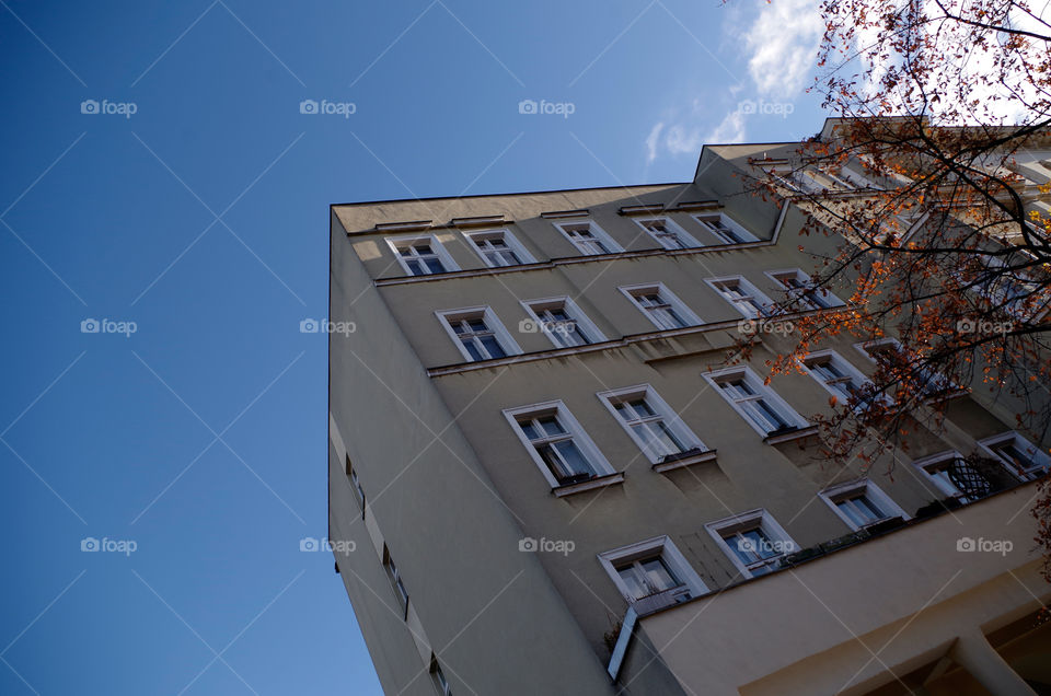 Low angle view of building exterior against blue sky in Berlin, Germany.
