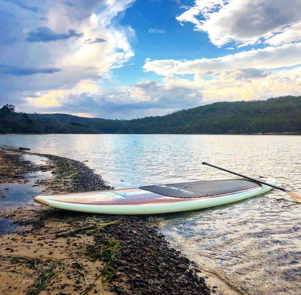 The stand up paddle board on the beach 