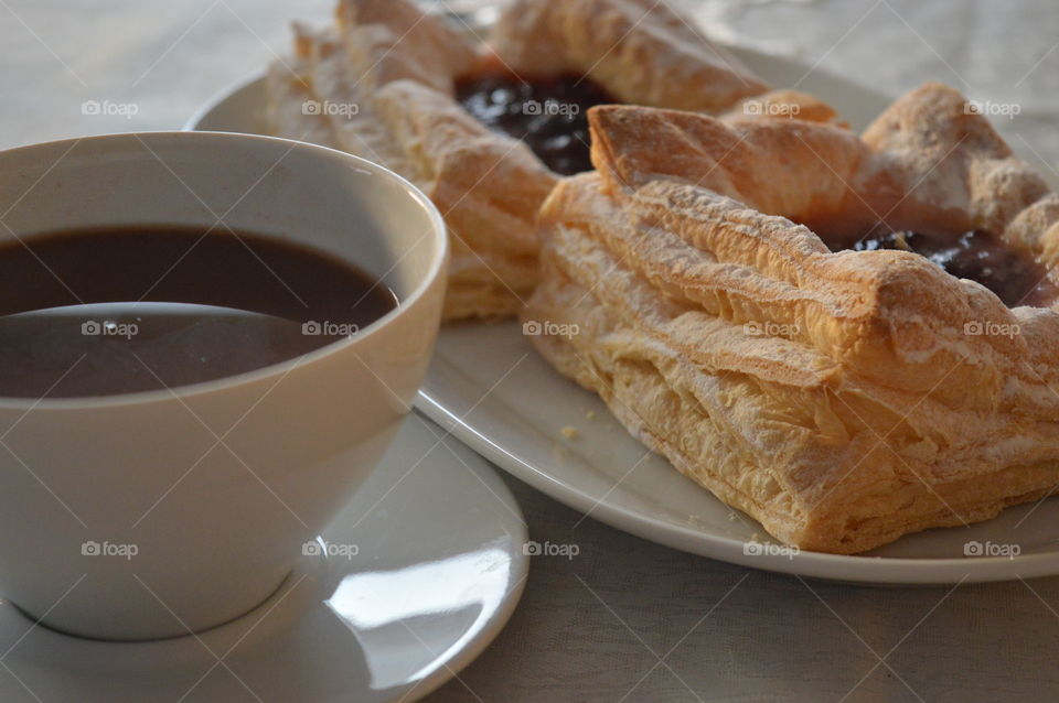 Close-up of coffee cup of pastry