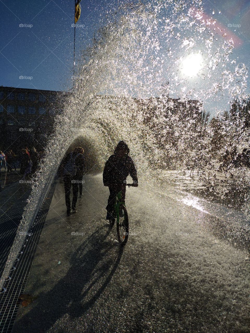 sportsman, cyclist under the fountain