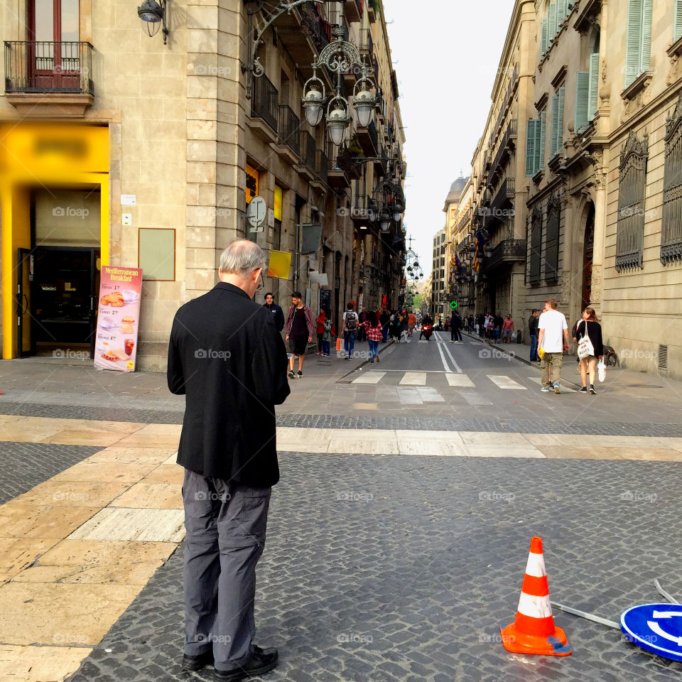 Elderly man standing on the middle of the street