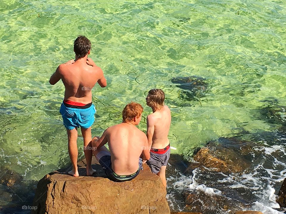 Local youth having fun at seashore in south Australia and about to go snorkelling 