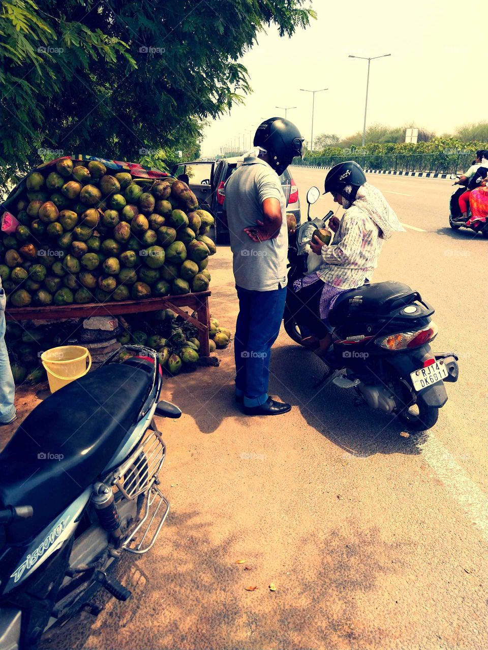 Drinking coconut water by wearing a helmet