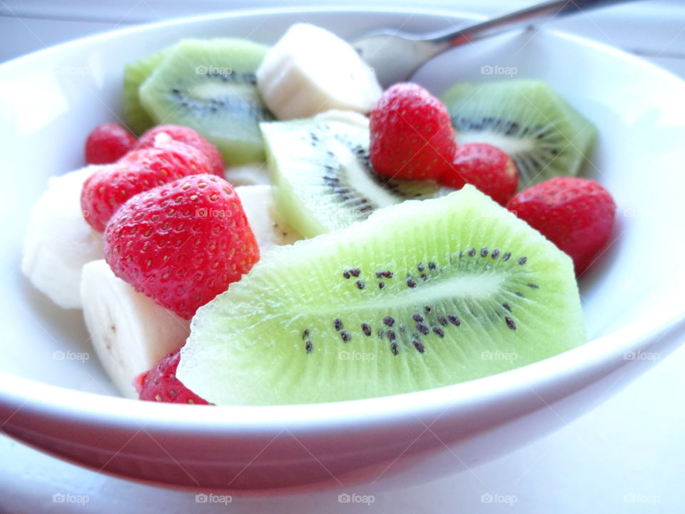 Healthy fruits breakfast full of vitamins with strawberry, kiwi and banana