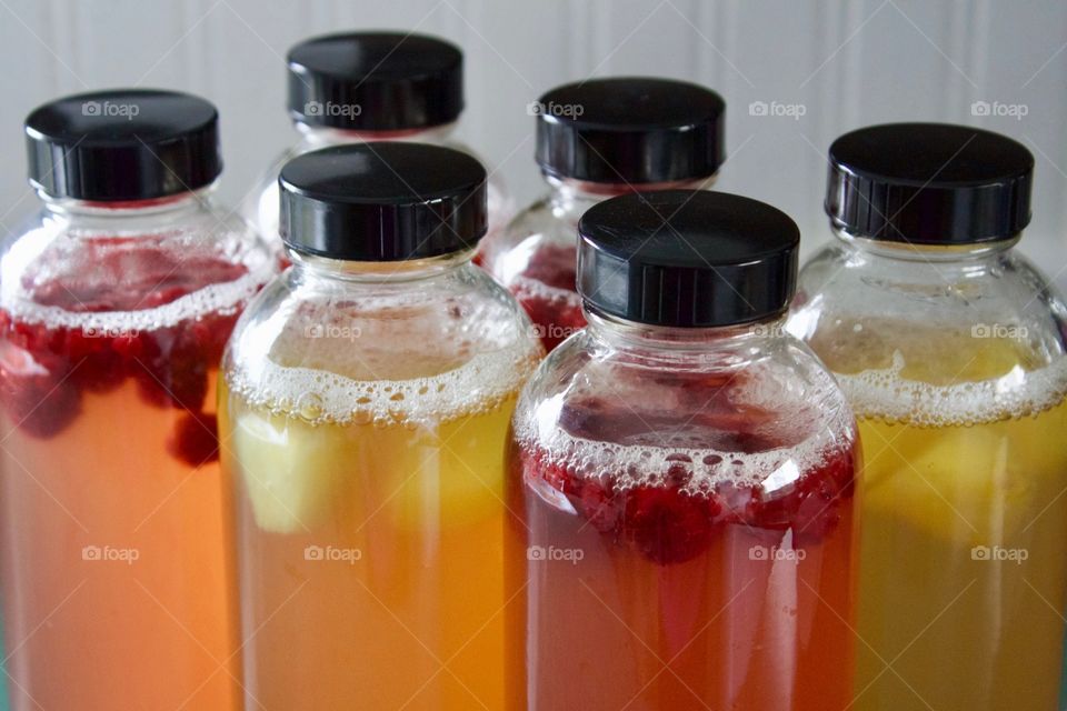 Raspberry- and pineapple-infused, home-brewed kombucha in bottles for flavorings and a second ferment - - a different kind of bubbly! 