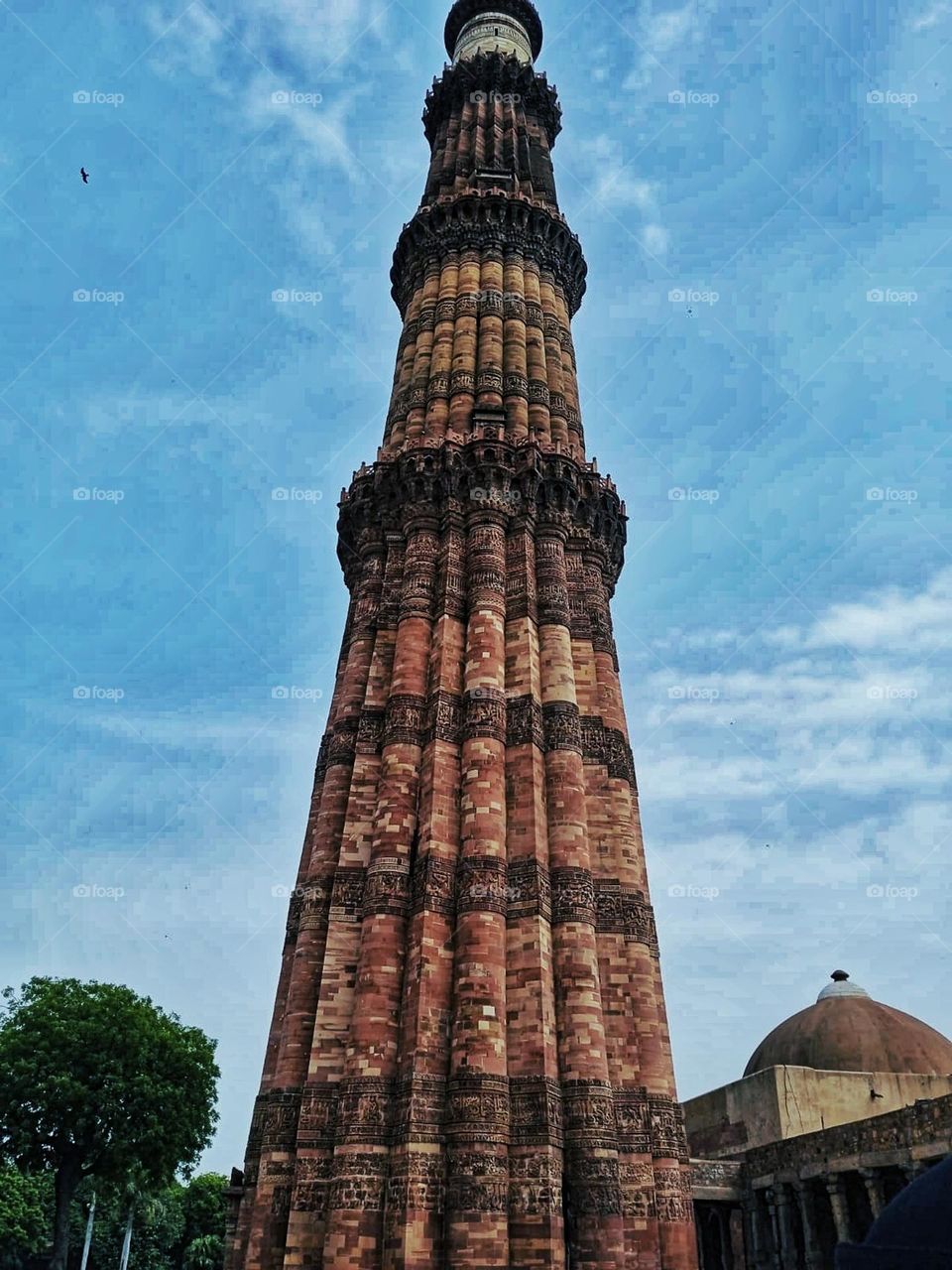 The large clock tower next to the tall building looks quite impressive! It's like a majestic sight in the cityscape. ⏰🏙