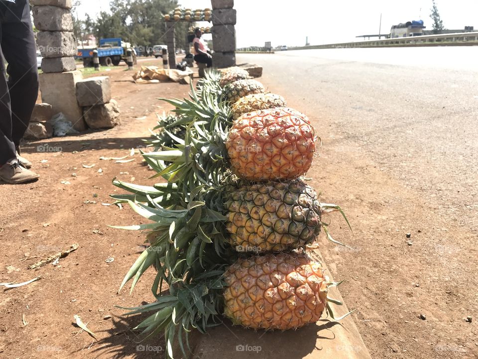 Pineapples ready for sale .this is a busy superhighway where many people come to buy .they are the best pineapples in Kenya ad also best for export