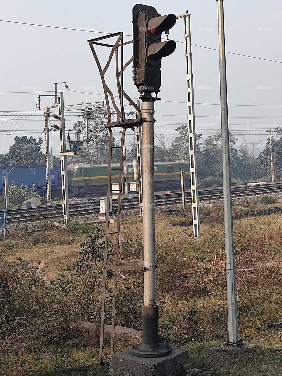 traffic signal pole near railway gate.