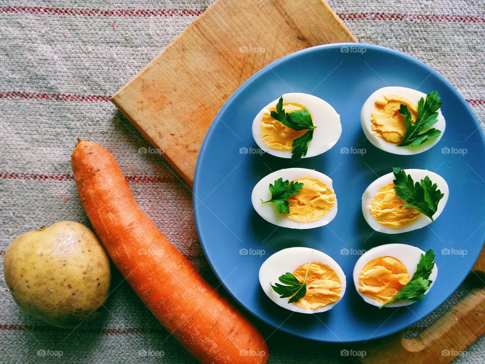 cut boiled eggs decorated with parsley