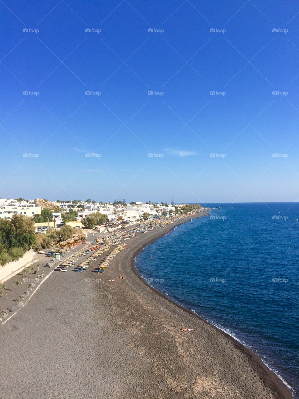 Summer beach on Santorini . Summer Kamari beach on Santorini island, Mediterranean sea, Europe 