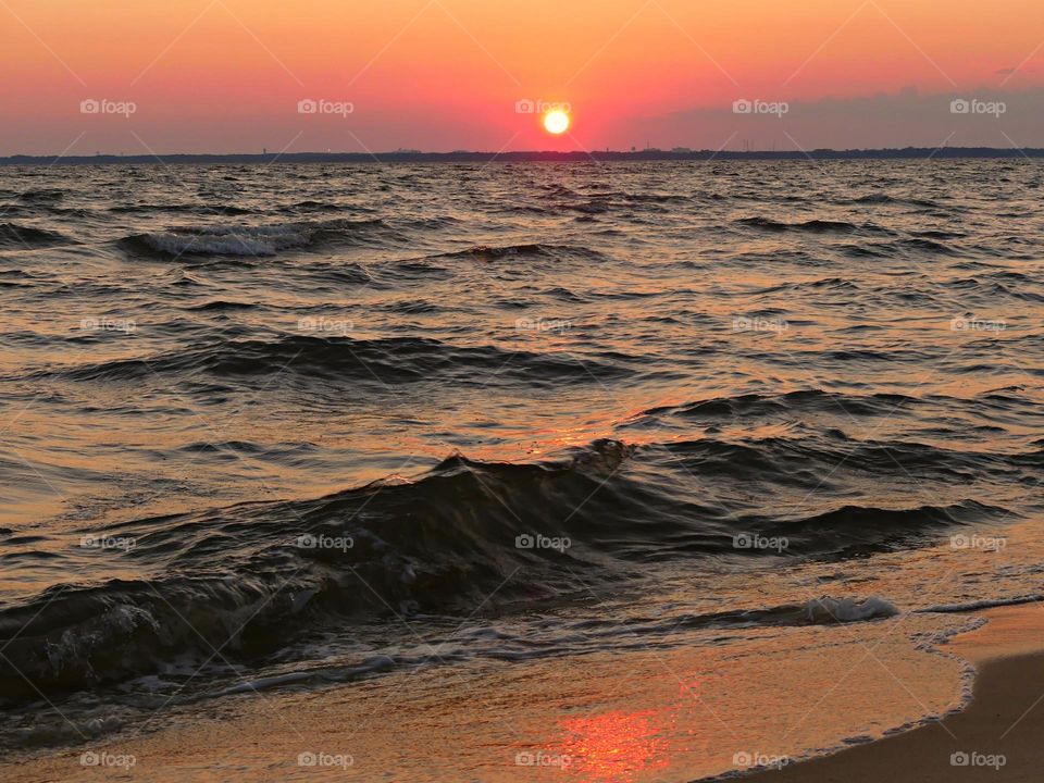 Not every sunset is the same. Sometimes the sky is completely aflame and other times the sun just delicately dips into the ocean, as it bids us goodnight. Sun reflects across the ocean waves 