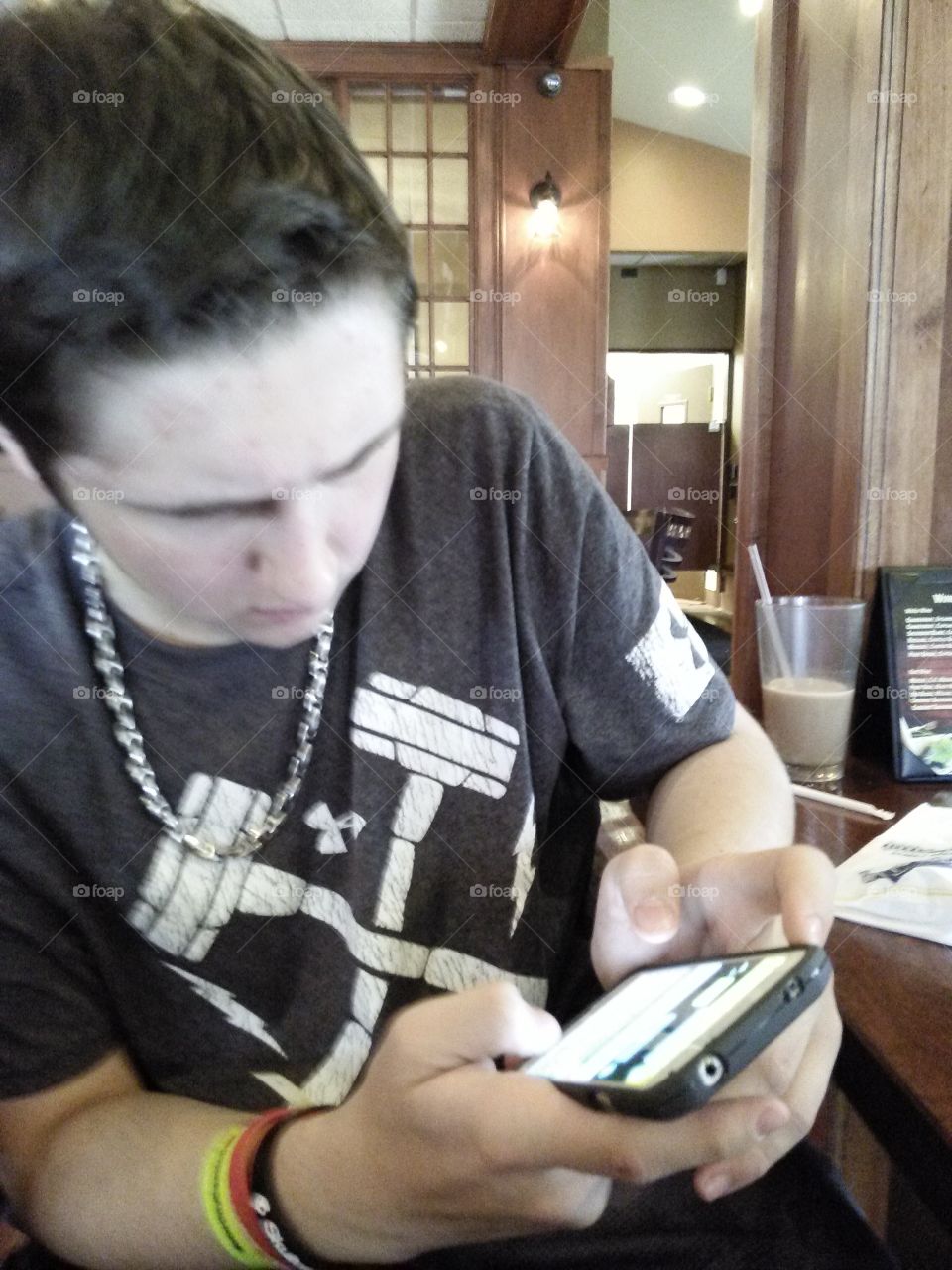 stop looking at your phone and eat. My son, staring at his cell phone instead of his plate  