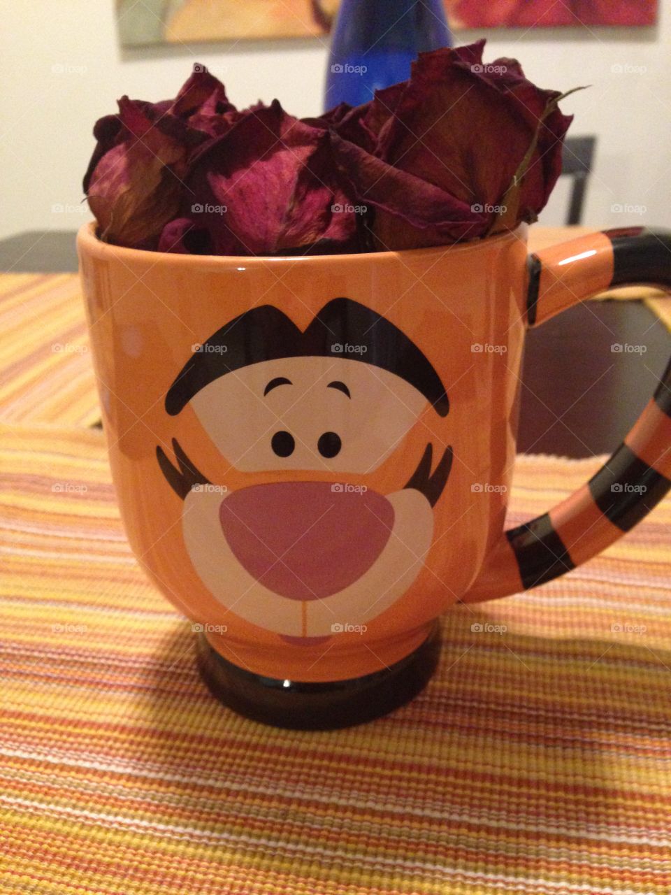 Roses placed in a Tigger mug from Disney World