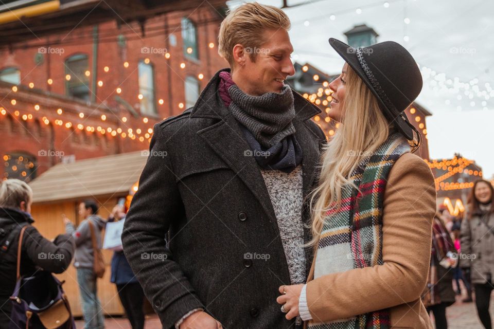 Happy Couple Under Holiday Lights