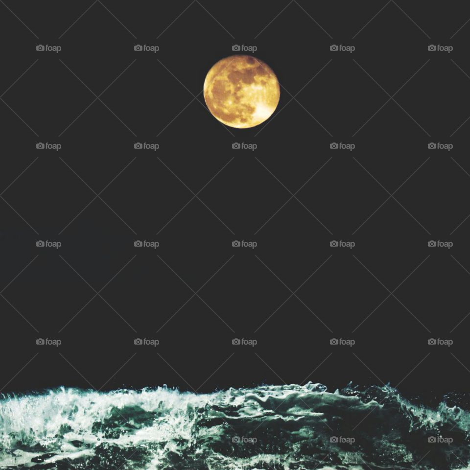 The moon attracts the sea water.