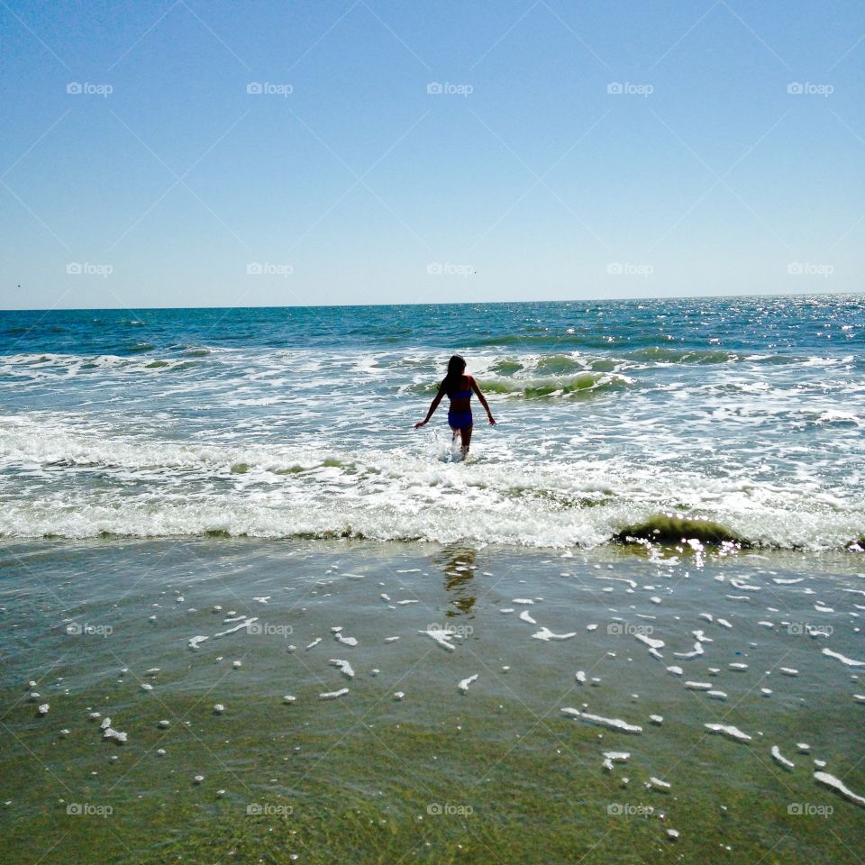 Girl walking the surf