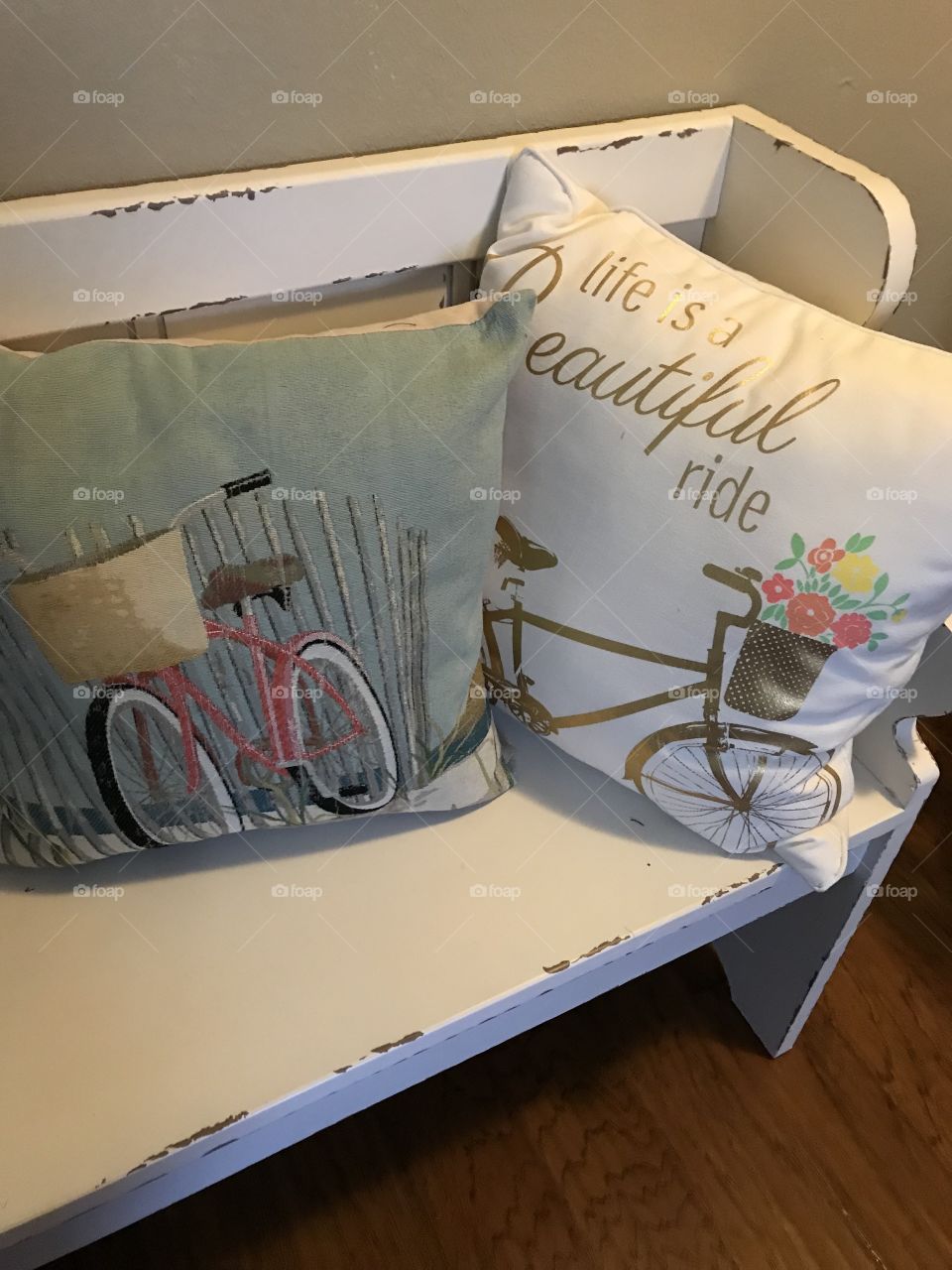 Life is a beautiful ride. Throw pillows on a white distressed bench.