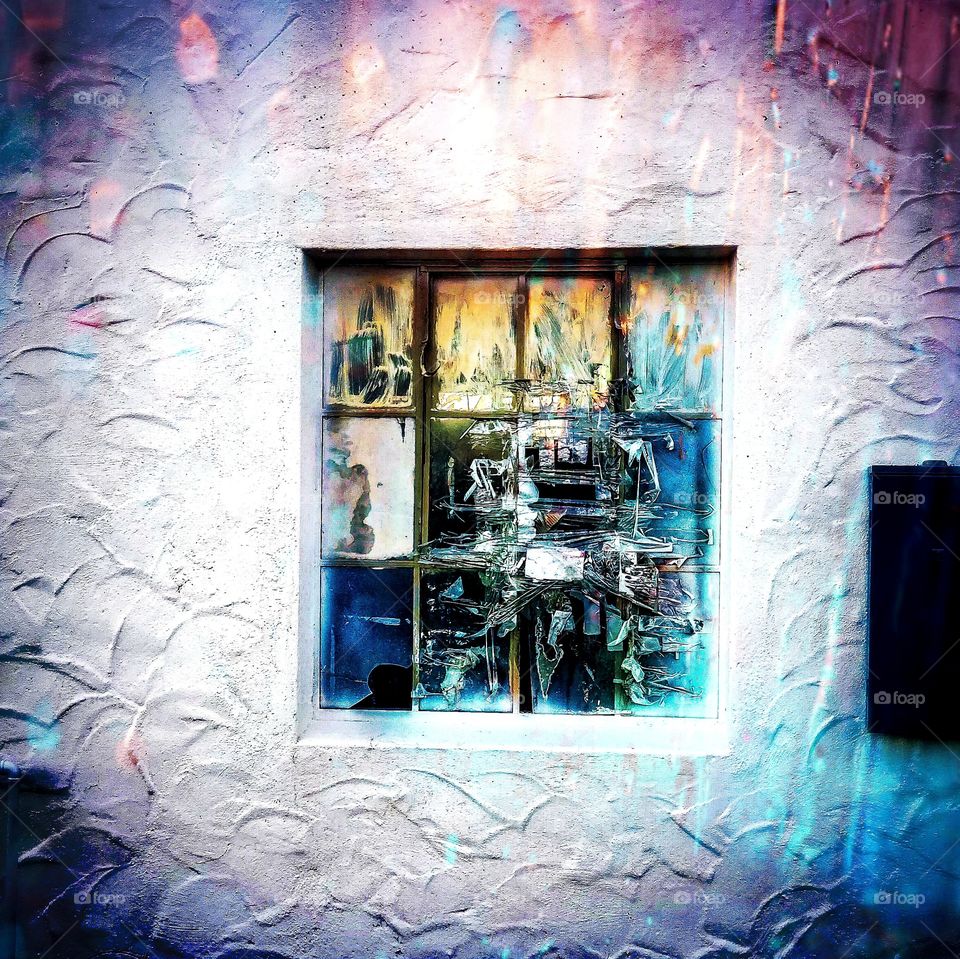 Window lites of life ... minimalist abstract 12 lite window on a white textured wall. Each of the window lites have abstract illusions subject to interpretation of the viewer and reflective of the chaos and colorful nature of life.