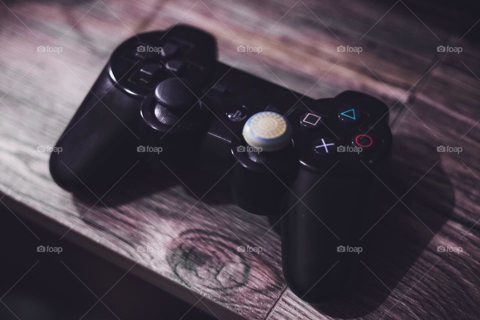 Playstation gamepad controller single player mode on a desk.