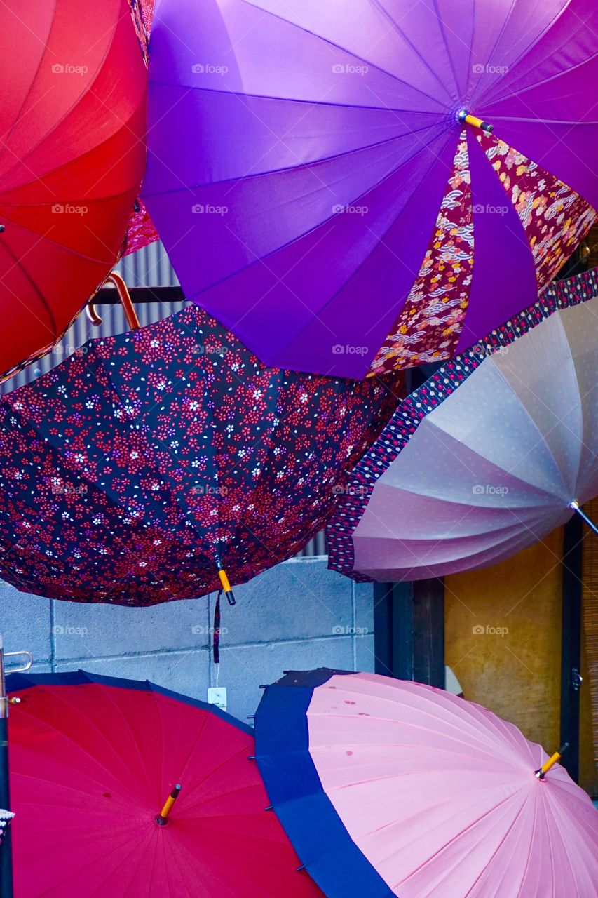 Umbrella Sale. Colourful umbrellashanging on a wall
