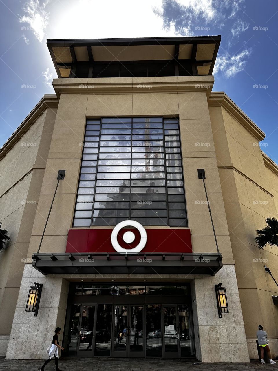 IPhone photo of front entrance to Target store showing facade with stationery awning, sconces, window and Target logo