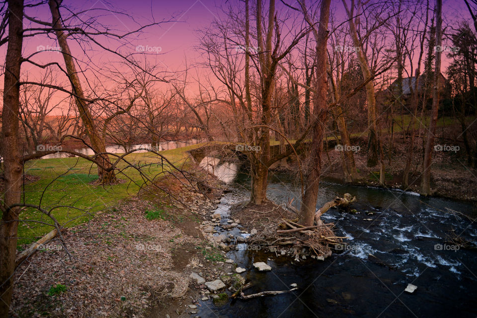 sunset bridge. old moss covered bridge at sunset