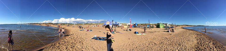 Panoramic view of beach and tourists enjoying