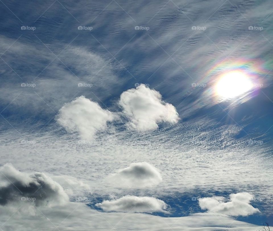 Clouds and sunrays on a sunny day